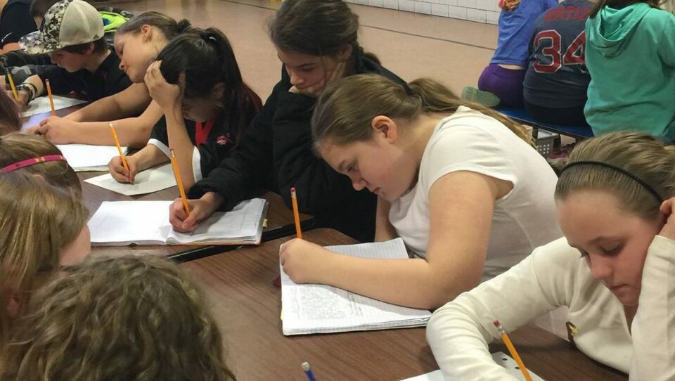 Students working on a writing assignment during a school activity