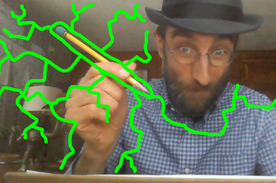 A man in a hat makes an expressive face while holding a pen, surrounded by green lightning graphics.