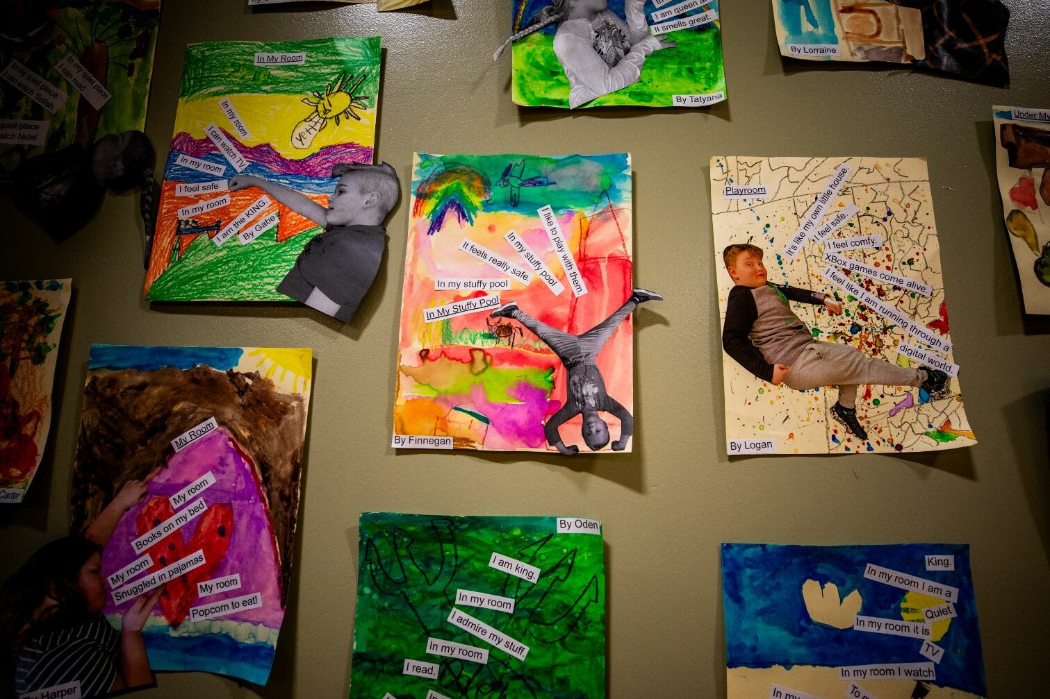 Children's art display featuring colorful drawings and collages about their rooms and activities.